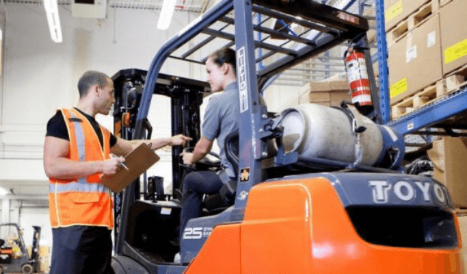 Instructor teaching student forklift safety