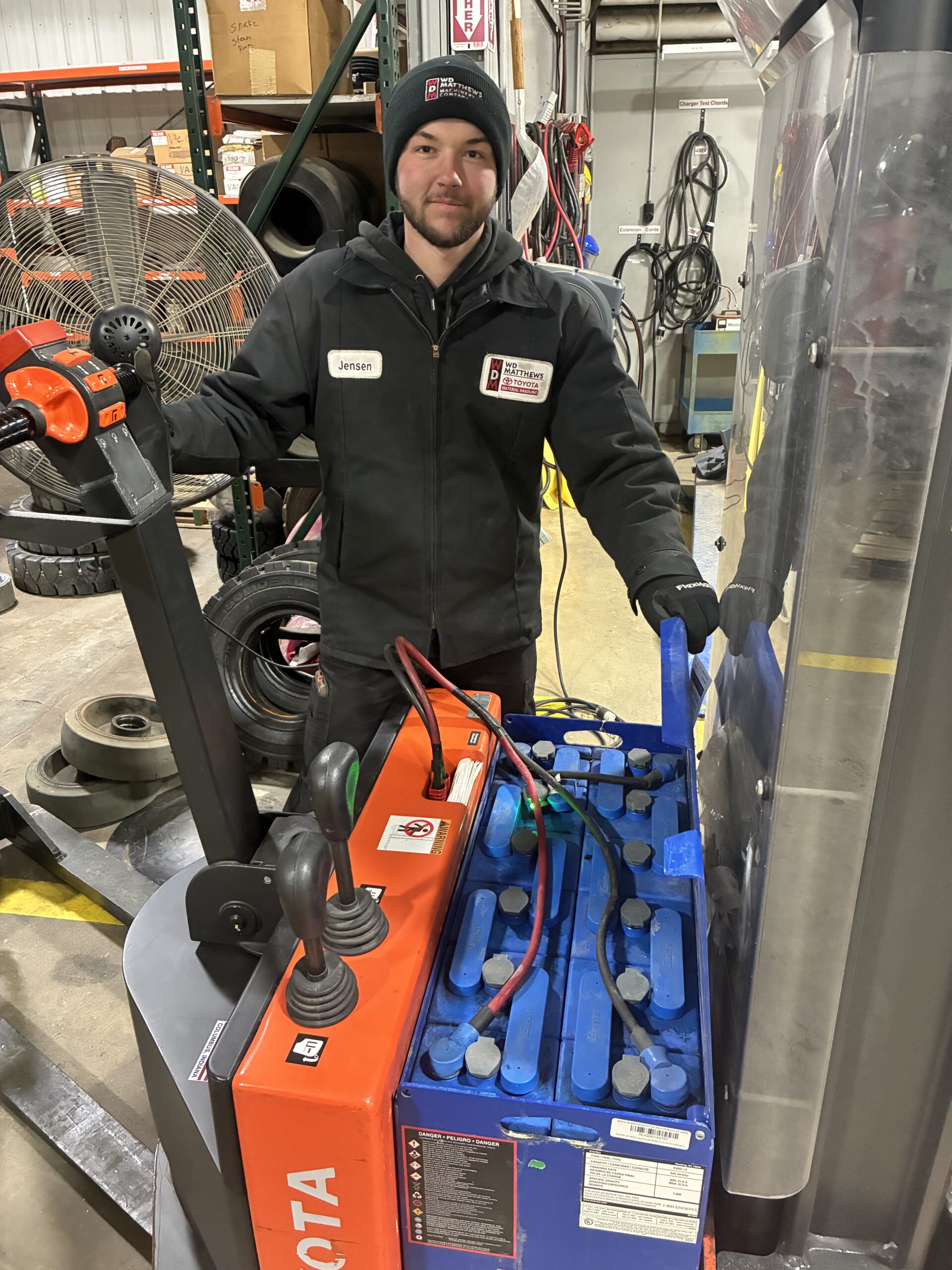 Electric forklift operating in cold warehouse with properly maintained battery during New England winter
