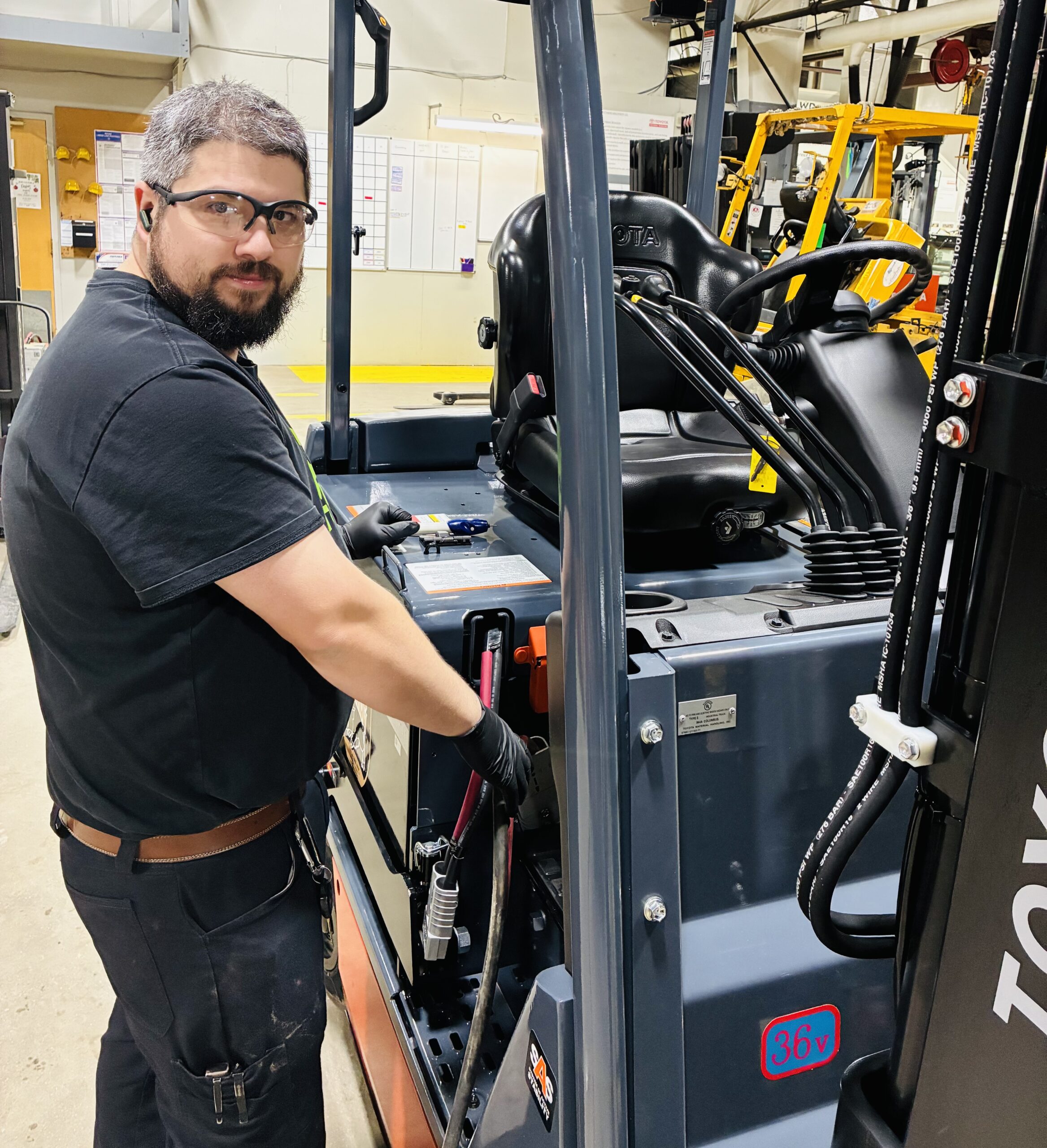 W.D. Matthews technician performing winter forklift battery maintenance and equalize charging in New England warehouse